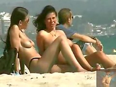 Topless brunettes on the beach