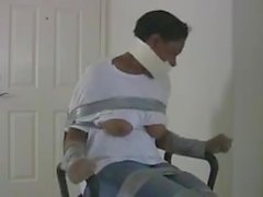 Sexy and erotic black girl wrap gagged and bound on the chair